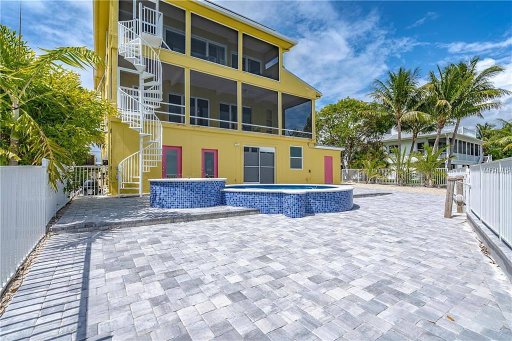 Commercial painters applying fresh coat of paint to large business property cape coral fort myers florida